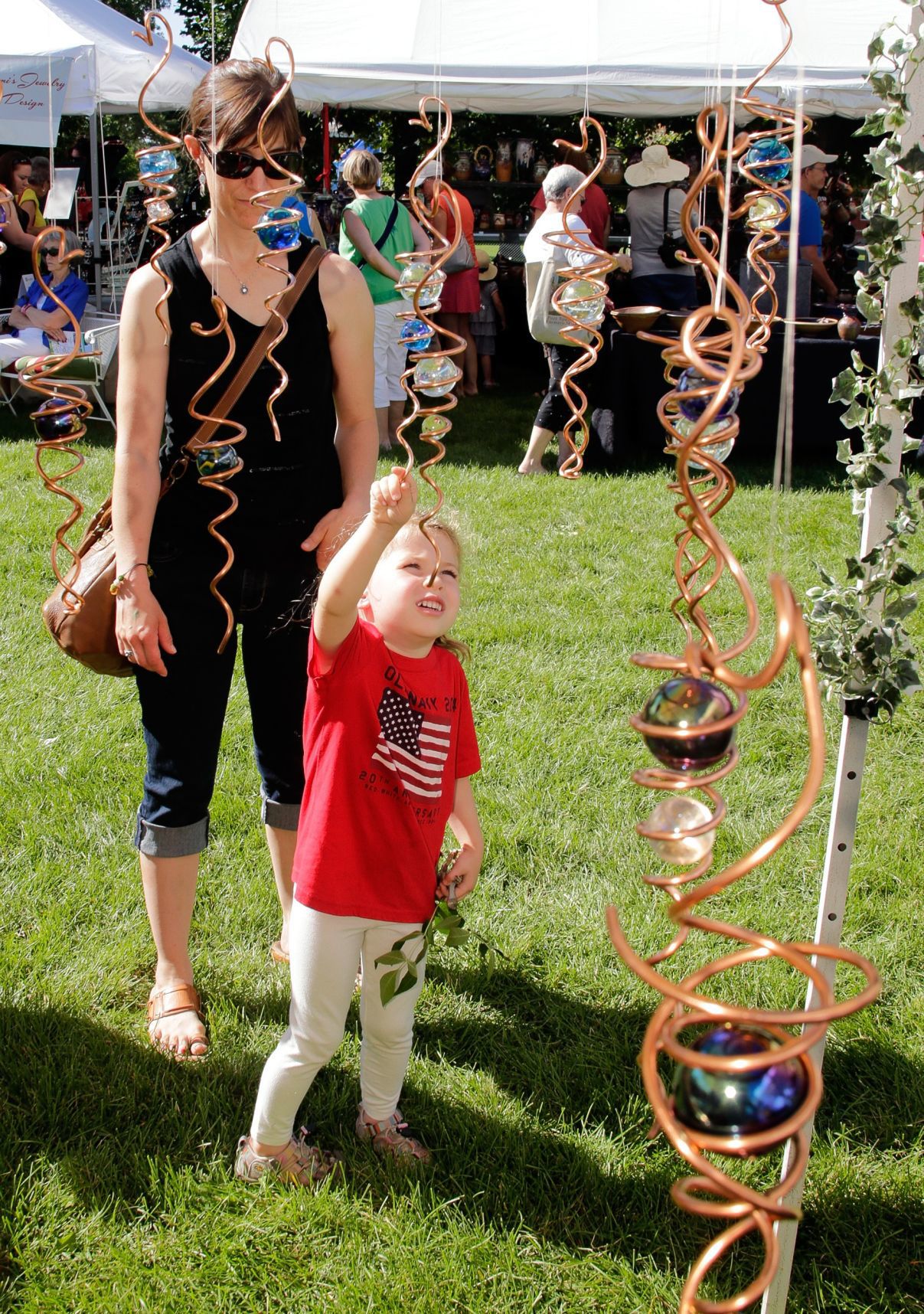 Madiline Felder, 4, looks at the spinning art